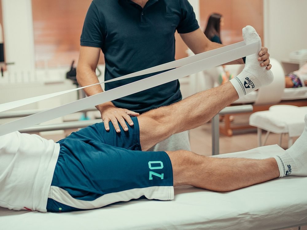 Close-up of physiotherapy treatment being provided to a patient's leg